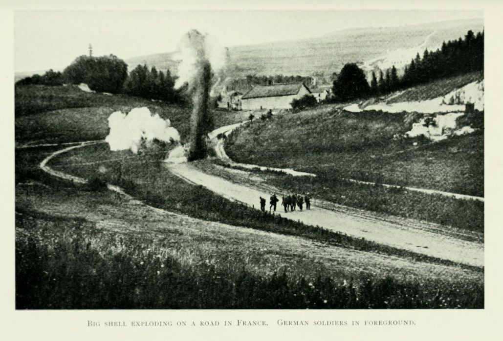 Big shell exploding on a road in France. German
soldiers in foreground.