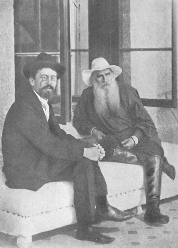 Tolstoy and Chekhov seated on a cushioned bench in front of an open window.