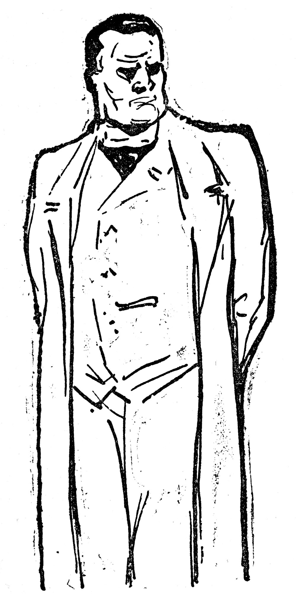 A man in a suit and an overcoat is standing.